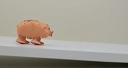 Motion of a walking toy on an inclined plane