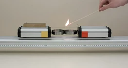 ばねで互いに押し出される異なる質量の小型車二台